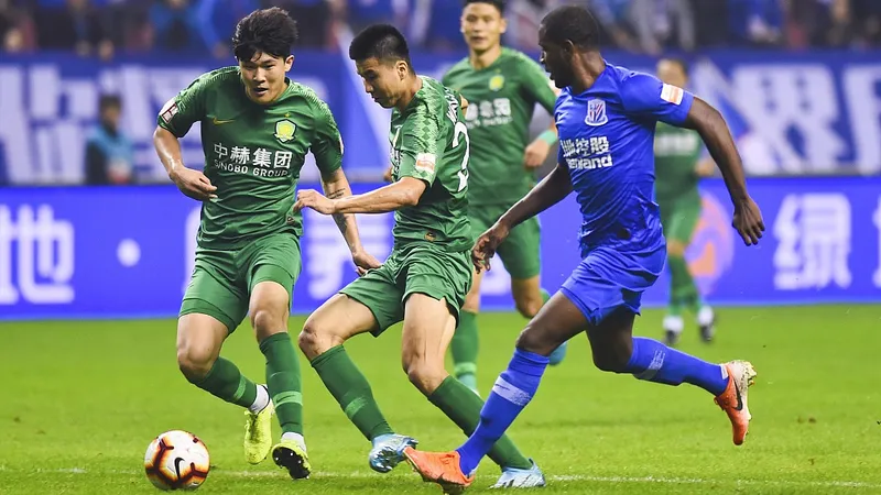 Cầu thủ Shanghai Shenhua và Beijing Guoan cạnh tranh quả bóng Cầu thủ Shanghai Shenhua và Beijing Guoan cạnh tranh quả bóng